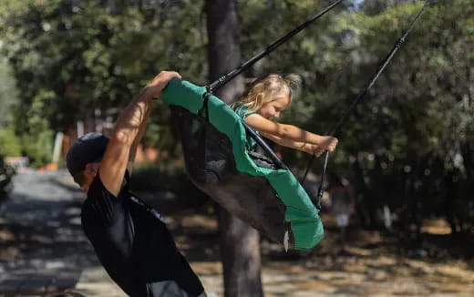a man and a woman on a swing