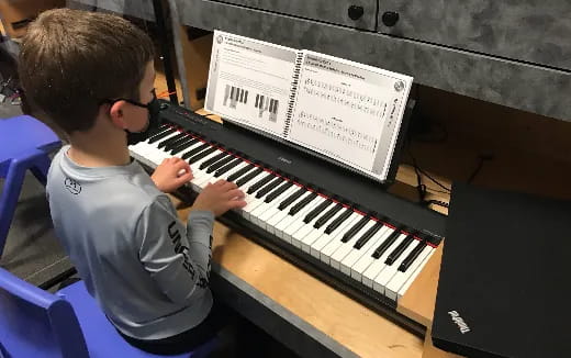 a boy playing a piano