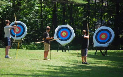 a group of men holding blue and white targets
