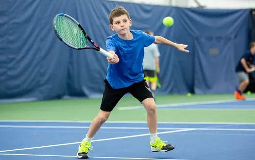 a boy playing tennis