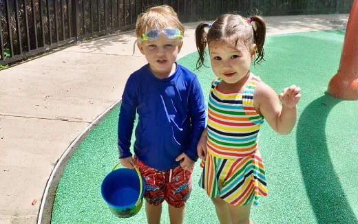 a couple of children holding buckets