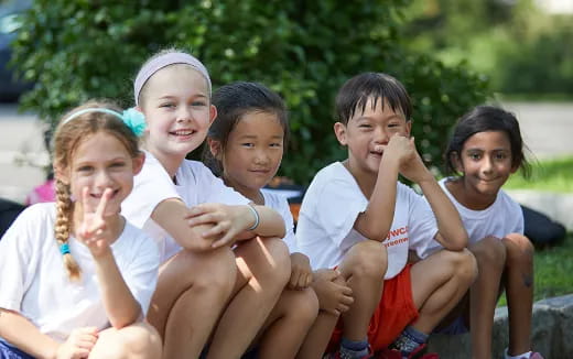 a group of children sitting on a bench