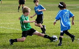 kids playing football on a field