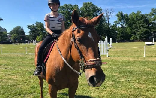 a girl riding a horse