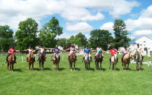 a group of people riding horses