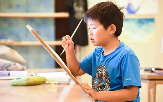 a young boy painting