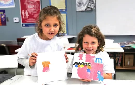a couple of young girls in a classroom