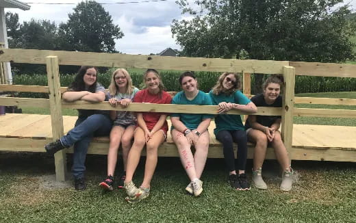 a group of people sitting on a bench
