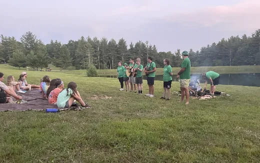 a group of people standing on grass