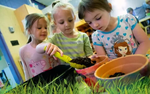 a group of children playing with dirt