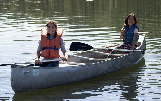 a couple of girls in a boat