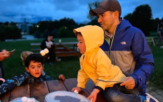 a man and a boy sitting outside