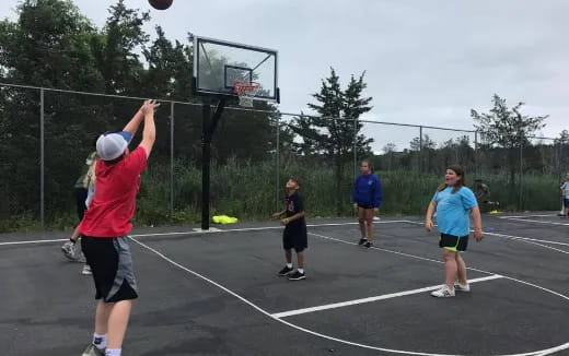 a group of people playing basketball