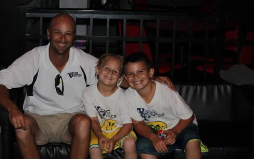 a group of people sitting together smiling