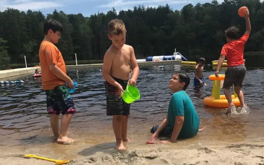 a group of boys playing in the water