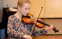 a girl playing a violin