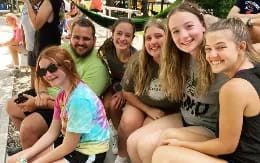 a group of people sitting together smiling