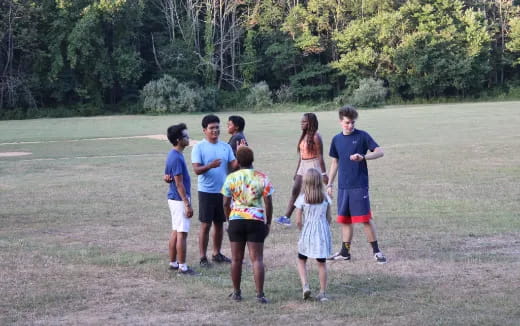 a group of people walking on a dirt path