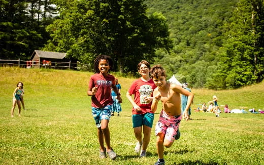 a group of boys running in a field