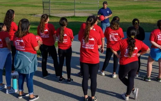a group of people in red shirts