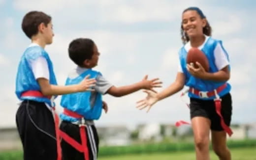 a group of kids playing basketball