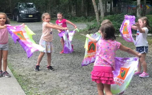 a group of children holding kites