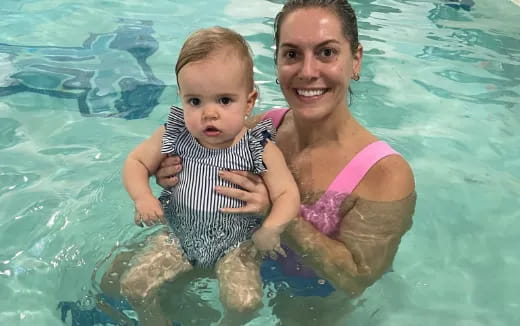 a person and a baby in a pool