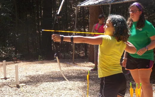 a group of people holding sticks