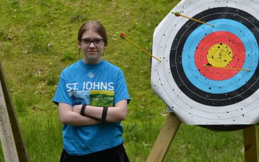 a man standing next to a painting