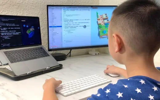 a boy using a computer