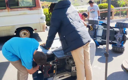 a group of people working on a car