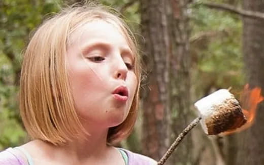 a girl with a bird in her mouth