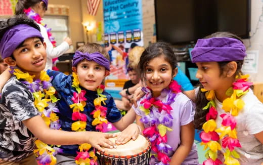 a group of children holding a cake