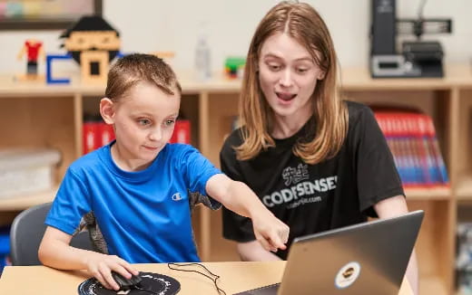 a person and a boy using a laptop
