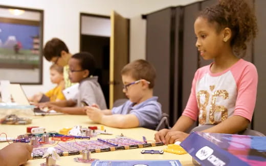 a group of children sitting at a table