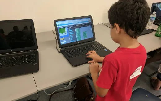 a boy using a laptop