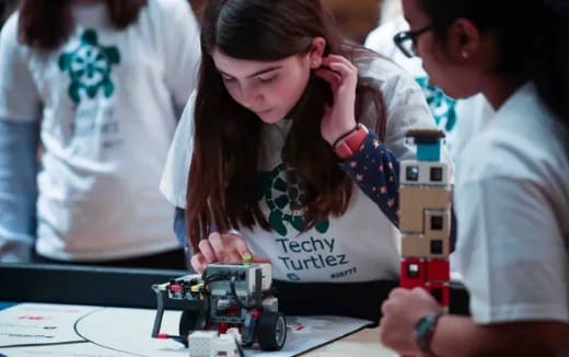 a group of people playing with a robot
