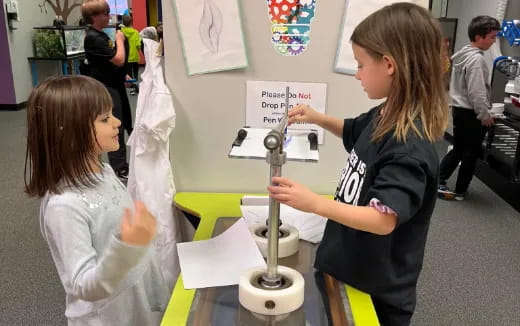 a person showing a girl something on a paper