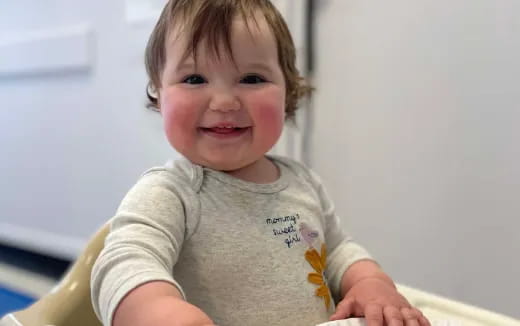 a child smiling at the camera