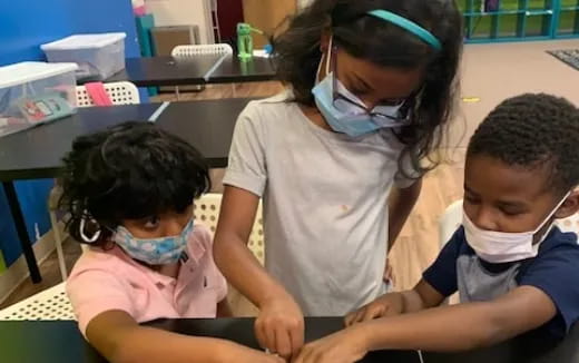 a group of children wearing masks