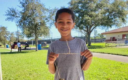 a boy holding a string