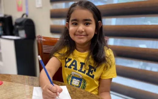 a girl sitting at a table