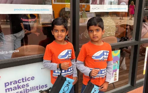 two kids in orange shirts