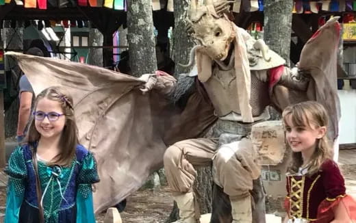 a group of people posing with a person in a garment