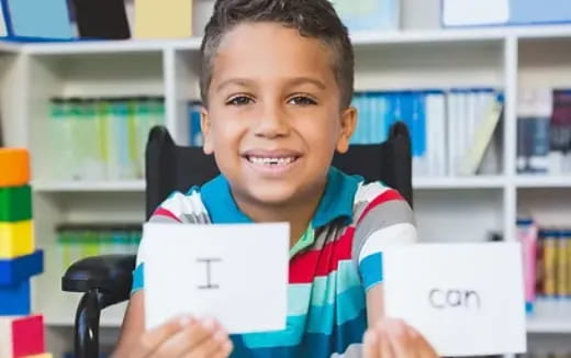 a boy holding a piece of paper
