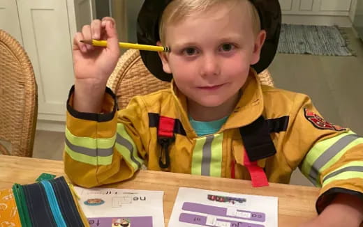 a boy holding a pencil