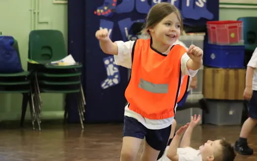 a girl in an orange vest