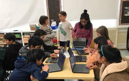 a group of people using laptops