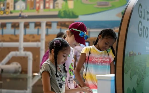 a group of girls looking at a paper