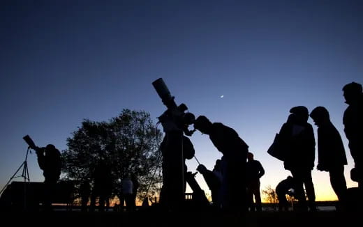 a group of people standing around a statue